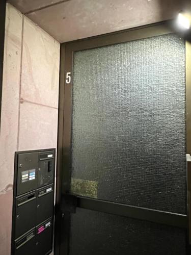 a large glass door in a room with aerate at Sahara Hosting Apartments Nürnberg City Room 3 in Nürnberg