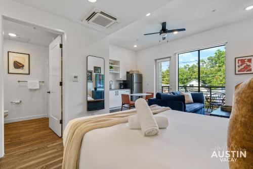 a bedroom with a bed and a living room at Vibrant Austin Studio Balcony plus Parking and Wi-Fi in Austin
