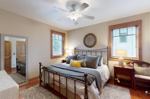 a bedroom with a bed and a ceiling fan at Luminous Pine Hideaway in Valle Crucis