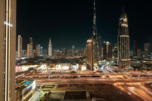 a view of a city at night with traffic at Stunning Two-Bedroom Apartment with Skyline View & walk to Dubai Mall by TerraHome in Dubai