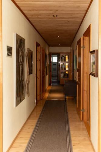 a hallway of a house with a long rug on the floor at Keltainen talo - tilava huvila lähellä Saloa in Vartsala