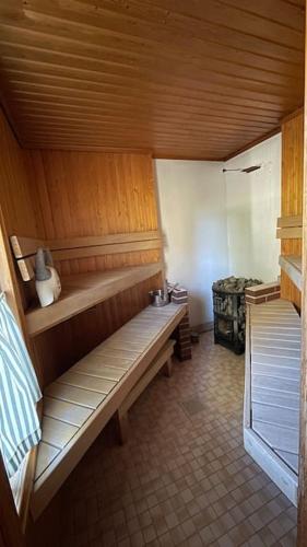 a room with a wooden bench in a room at Keltainen talo - tilava huvila lähellä Saloa in Vartsala