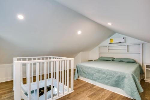 a bedroom with a bed and a crib at Walk to Winery Holt Home 8 Mi to State Park! in Kearney