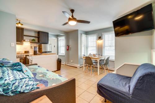 a living room with a couch and a kitchen at Less Than 1 Mi to Boardwalk and Beach Access Ocean City Apt! in Ocean City