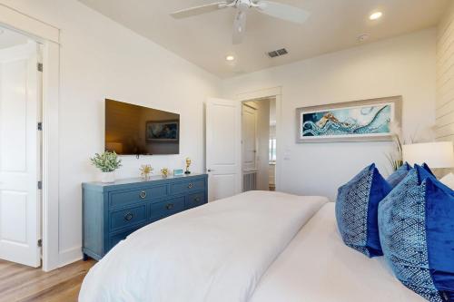 a bedroom with a bed and a blue dresser at Sabal by the Sea in Port Aransas