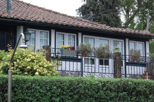 a house with a fence with potted plants on it at Casa da Quinta De S. Martinho in Vila Real