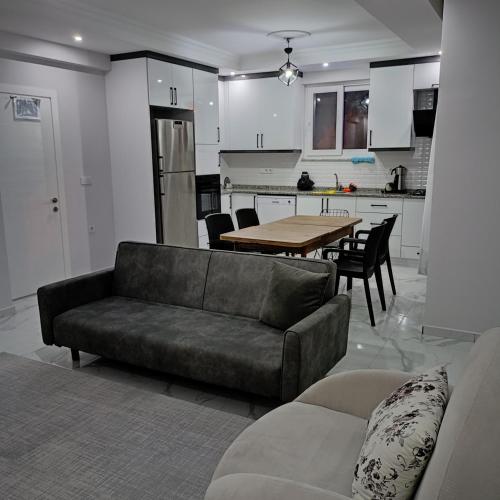 a living room with a couch and a table in a kitchen at Lavender Villas in Dalaman