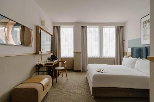 a hotel room with a bed and a desk at Club Quarters Hotel St Paul's, London in London