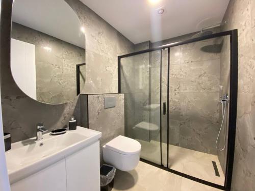 a bathroom with a shower and a toilet and a sink at Boutique 16 - Alanya Experience in Alanya