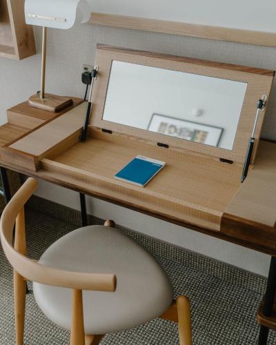 a desk with a chair and a mirror on it at Club Quarters Hotel St Paul's, London in London