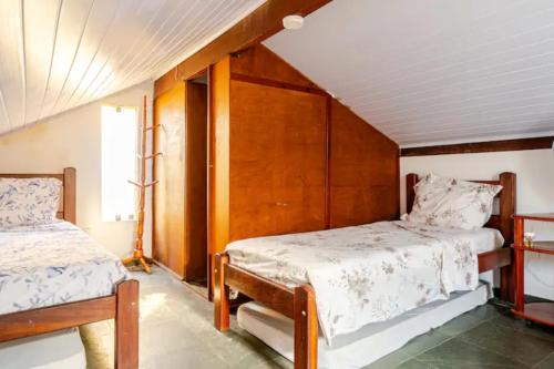 En eller flere senge i et værelse på Nossa_Casinha_Pé_na_Areia