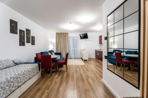 a hotel room with a bed and a table and chairs at Wise Nest Studio in Sinaia