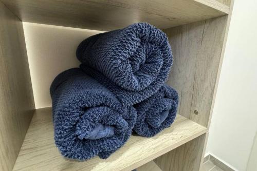 a pile of blue towels sitting on a shelf at Exclusive pool house in Bahía Kino
