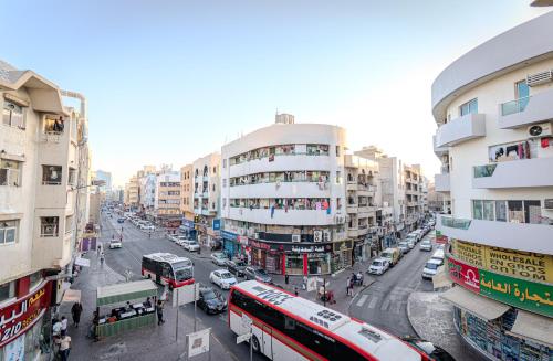 a busy city street with buses and cars at City Relax Hotel in Dubai