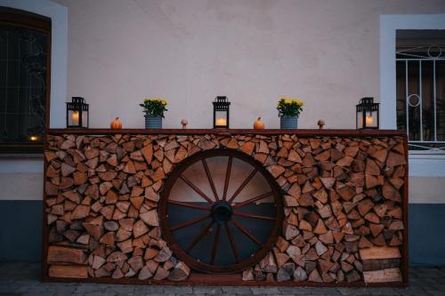 a table with candles on top of a pile of fire wood at Hotel Leo in Steyr