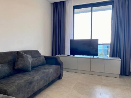 a living room with a couch and a flat screen tv at Boutique 16 - Alanya Experience in Alanya