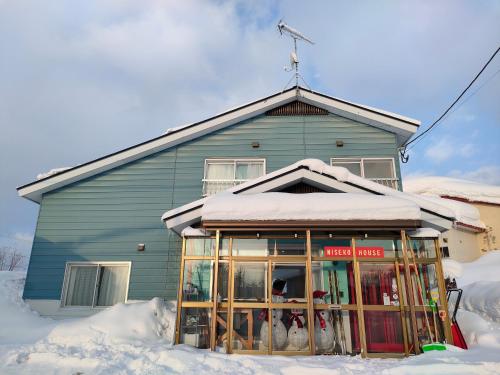 a house with snow on the ground in front of it at TR Niseko House Room Lavender in Niseko