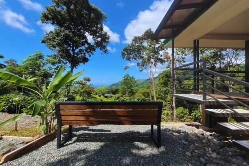 a wooden bench sitting in front of a building at Casa Kabuae in Portalón