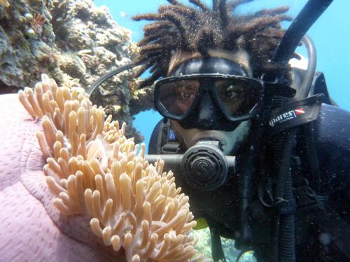 a man in a diving mask and an anemoxin at Kadidiri Paradise in Batudaka