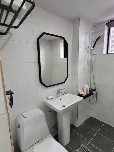 a bathroom with a sink and a toilet and a mirror at stay110 in Seoul