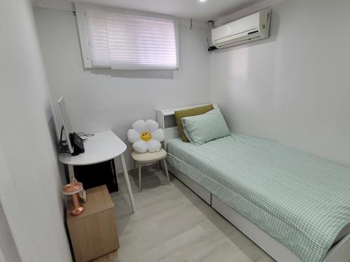 a small bedroom with a bed and a table at stay110 in Seoul