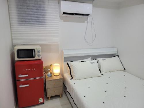 a bedroom with a bed with a tv on top at stay110 in Seoul