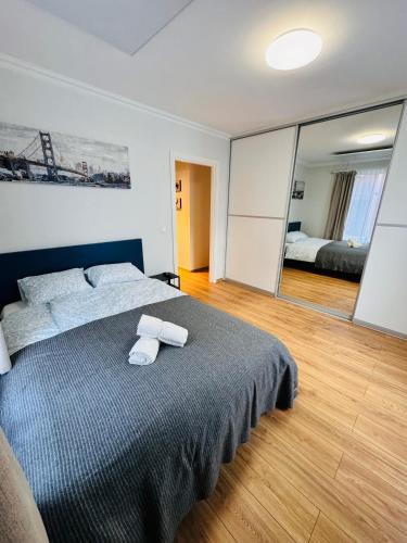 a bedroom with a bed with two towels on it at Tallinn Downtown 1BR apartment with parking in Tallinn