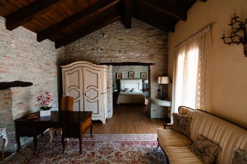 a living room with a couch and a bedroom at Cadgal - Tenuta La Cova in Calamandrana