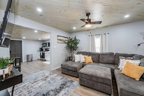a living room with a couch and a ceiling fan at Aviation Haven 5 Mins to RIC, Ready for Takeoff! in Capitol View