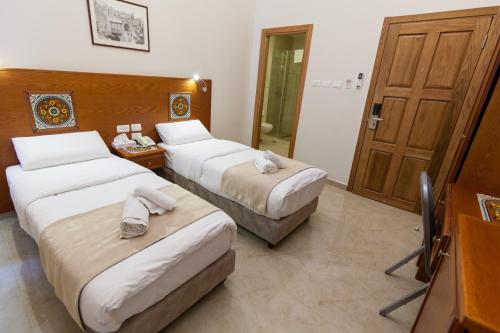 Postel nebo postele na pokoji v ubytování Azzahra Boutique Hotel & Restaurant - Jerusalem