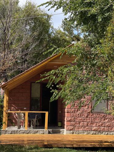 a small red brick house with a porch at Forest Home in Sevan
