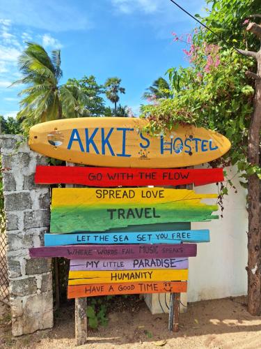 a sign for a surf shop with a surfboard on it at Akki's Hostel in Trincomalee