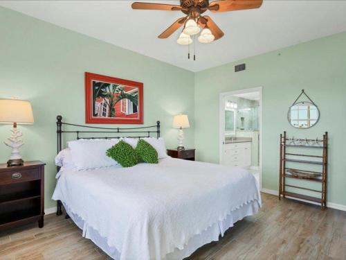 a bedroom with a white bed and a ceiling fan at Boca Vista - Unit B202 in Englewood