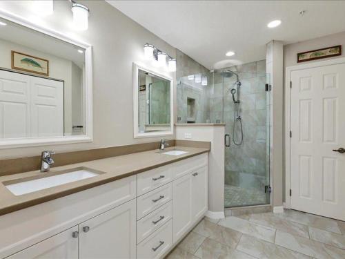 a bathroom with two sinks and a shower at Boca Vista - Unit B202 in Englewood