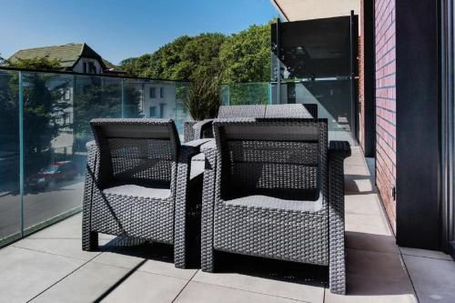 a pair of chairs sitting on a balcony at Wyspa Uznam Marina Jachtowa in Świnoujście