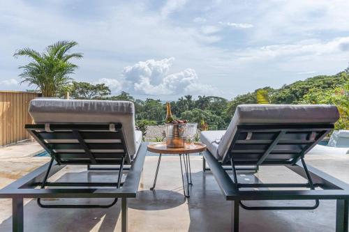 two chairs and a table on a patio at Stella Mar Ocean view in Santa Teresa Beach