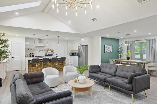 a living room with two couches and a kitchen at 3-BD Backyard Oasis w Pool Patio Firepit in Irving