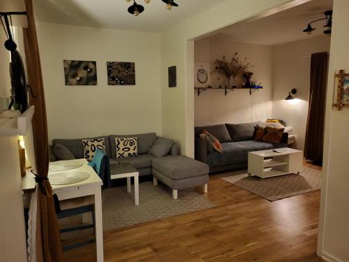 a living room with a couch and a table at Sahlin - Kattarp in Kattarp