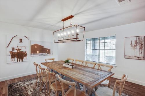a dining room with a wooden table and chairs at Your Rustic Retreat w Backyard Oasis Pool Patio in Keller