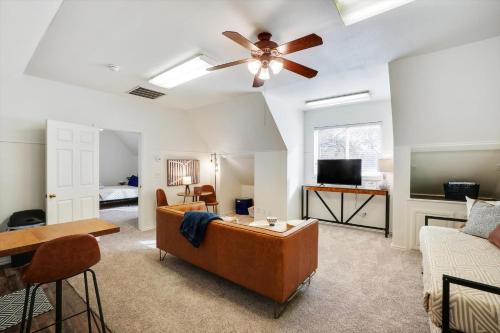 a living room with a couch and a ceiling fan at Your Rustic Retreat w Backyard Oasis Pool Patio in Keller