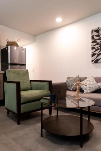 a living room with a couch and a chair and a table at Nuevo y moderno Departamento en zona de Santa Fe in Mexico City