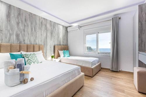 a bedroom with two beds and a window at Hi'Mare TOP Sea View 1 - Parking and Kitchen in Himare