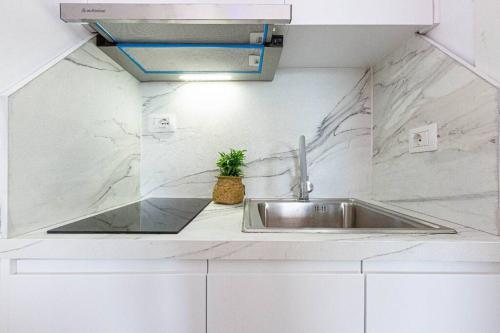 a kitchen with a sink in a white counter top at Hi'Mare TOP Sea View 1 - Parking and Kitchen in Himare