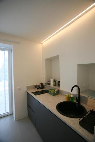 a kitchen with a sink and a counter at Il Carrubo in Procida