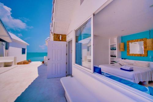 a bedroom with a bed and a view of the ocean at So KohKoon Beach Resort in Bang Rak Beach