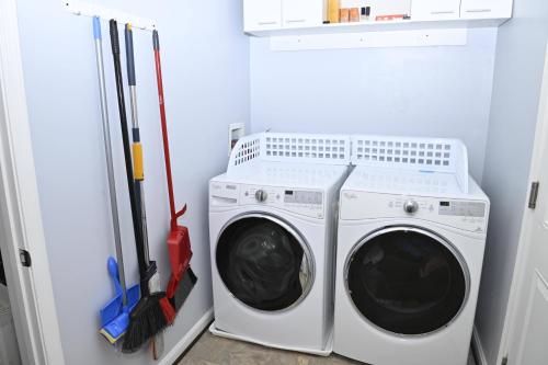 a laundry room with a washer and dryer at Luxury Living at Woodmore in Bowie
