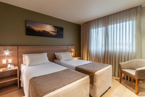 Ένα ή περισσότερα κρεβάτια σε δωμάτιο στο Hotel Laghetto Pedras Altas