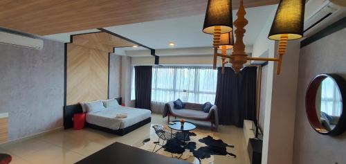 a living room with a couch and a chair at ARTEplus JALAN AMPANG, KLCC in Kuala Lumpur