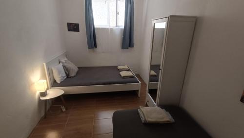 a small room with a bed and a mirror at Oleas Stari Grad Hvar - 2 Min To Center Ocean Bus Supermarket in Stari Grad