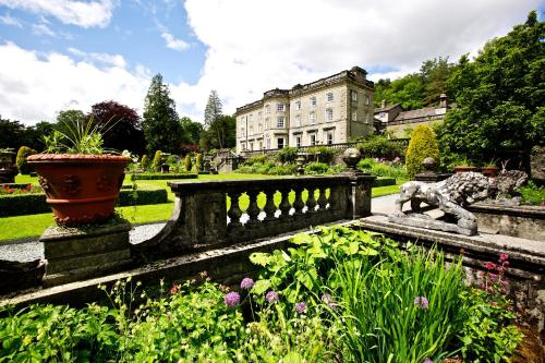 a garden with a statue of a dog on a fence at Rydal Hall Christian Retreat Centre in Rydal
